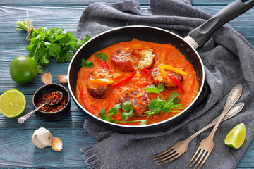 fish cakes in tomato vegetable coconut milk sauce
