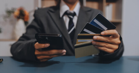 Online payment,businessman hands holding credit card and using  laptop for online shopping. Cyber...