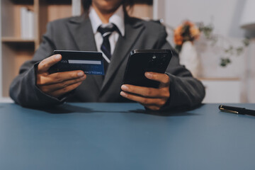 Online payment,businessman hands holding credit card and using  laptop for online shopping. Cyber...