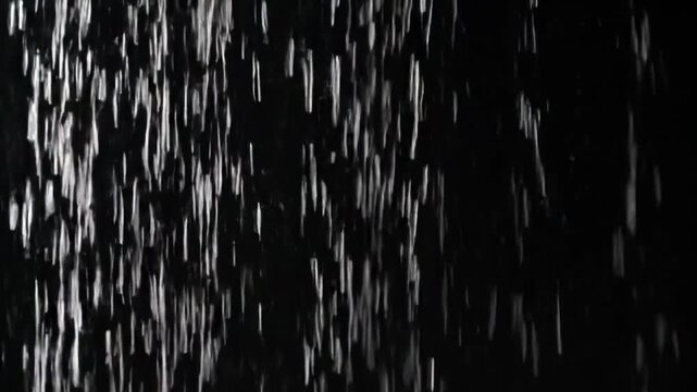 Rain on black background for easy chroma or luma keying. Clean, isolated droplets&mdash;perfect for overlays, VFX, and seamless compositing.