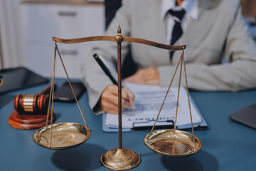 Judge gavel with Justice lawyers having team meeting at law firm background. Concepts of Law and...