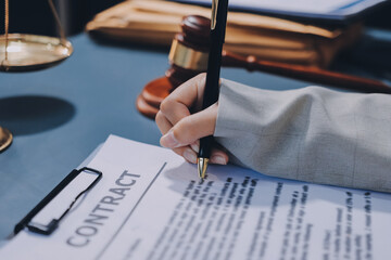 Judge gavel with Justice lawyers having team meeting at law firm background. Concepts of Law and...
