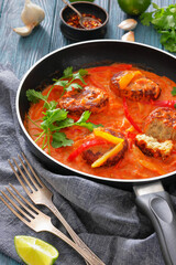 fish cakes in tomato vegetable coconut milk sauce