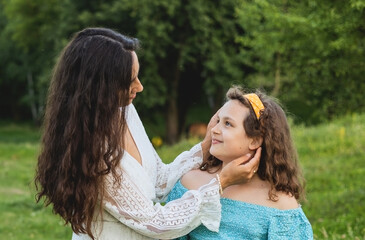 Mother and daughter against the backdrop of nature