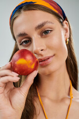 Radiating summer vibes, a young woman enjoys a colorful moment in the studio