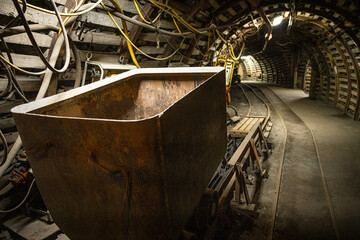Coal mine corridor with tracks, trolley and lighting