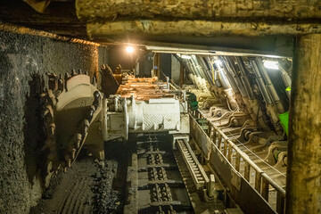 Longwall face with a shearer, scraper conveyor, and powered roof supports