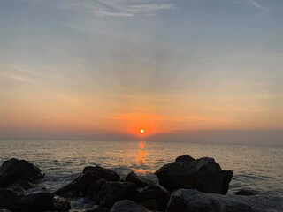 sunset at beach with rock on the beach