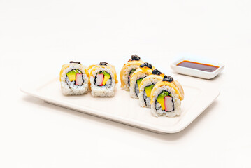 The rice is turned over so that the layer of rice with toppings is facing down on the makisu.