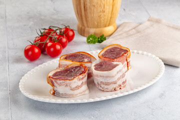 Raw pork tenferloin with bacon