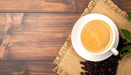 A cup of black coffee and roasted coffee beans on a wooden table, with a plant