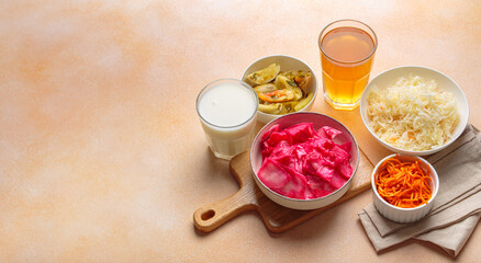 Fermented vegetables such as sauerkraut, pickled tomatoes, carrots, kimchi are displayed alongside a glass of kombucha and yogurt, highlighting the importance of probiotics for gut health