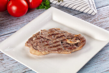 Grilled lamb steak with bone