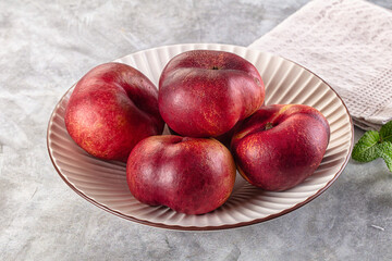 Ripe sweet juicy flat nectarines heap