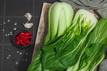 Fresh Bok choy on a trendy black tile background. Traditional Chinese cabbage vitamin ingredient