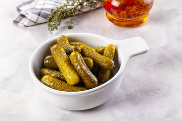 Marinated canned green cornichon cucumbers