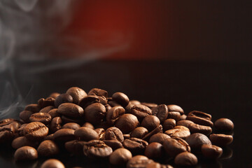 coffee beans on a dark background with a red highlight on the background, coffee beans close-up for a coffee shop