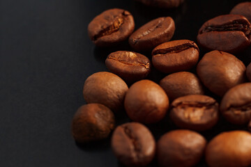 Coffee beans on a black background. Coffee on a black background with reflection