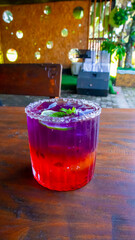a glass of cold mocktail served on the table