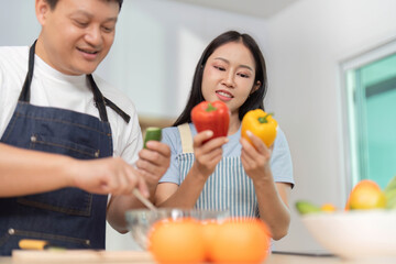 Healthy Meal Prep: Couple Choosing Fresh Ingredients in Kitchen