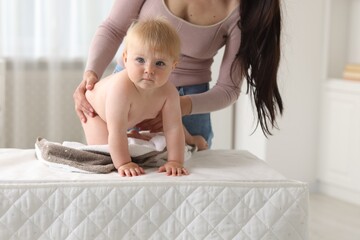 Mother with her cute baby at home, closeup