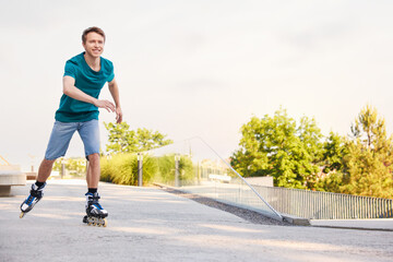 Happy man roller skating on city street. Space for text