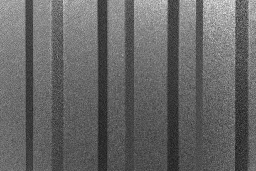 A close-up view of a corrugated metal surface, showcasing its vertical lines and textured finish.