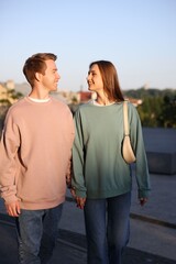 Lovely couple walking together on city street