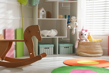 Stylish playroom with toys and furniture. Interior design