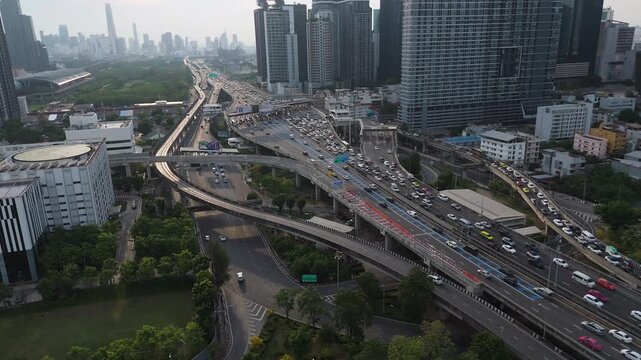 Aerial View Of Cars Driving Through The Sirat Expressway Along The High-rise Buildings In Bangkok, Thailand.
