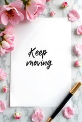 A white card features the inspirational message, Keep moving, framed by delicate pink blossoms scattered across a marble background, vertical composition.