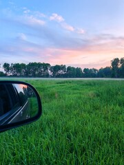 Beautiful summer landscape and peaceful view in the rainy season. vast green fields stretch out in...