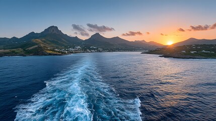 Ocean water wake mountains and sunset sky create a scenic travel destination.