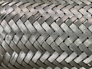 tire track background. Close-up of stainless steel braided hose texture. High-detail macro shot...