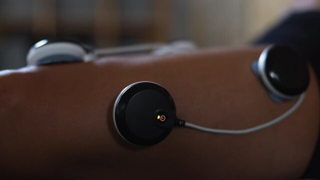 Close-up detail: Quad muscles twitch from electrical impulse electrodes