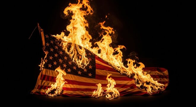 The flag of the United States of America burning on the ground in flames, representing dissent, social unrest, and political turmoil.