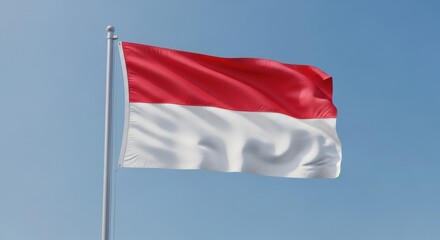 The flag of the Republic of Indonesia flying proudly on a flagpole against a clear, serene blue sky on a bright sunny day.