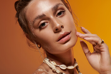 Summer beauty shines bright with a seashell necklace in a vibrant studio backdrop
