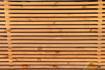 Clean wooden slats in natural tones arranged in parallel. Horizontal wooden slats background