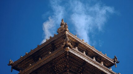 Ornate temple rooftop corner under a clear sky