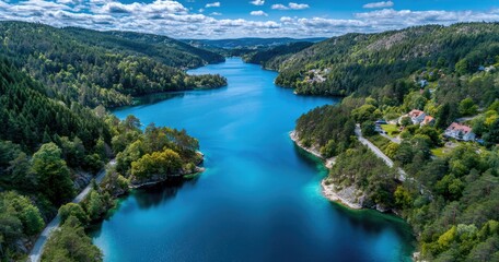Aerial view of an island with forests and small villages, surrounded by blue waters in Norway