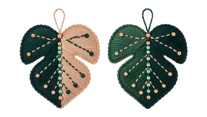 Two green and beige leaf ornaments with beads and stitching brown png image download 