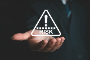 Risk warning sign over open hand, digital triangle hazard icon, danger assessment and risk management concept.