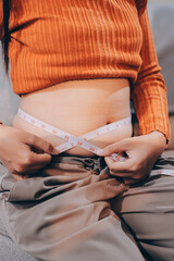 woman's hand holding excessive belly fat, overweight concept