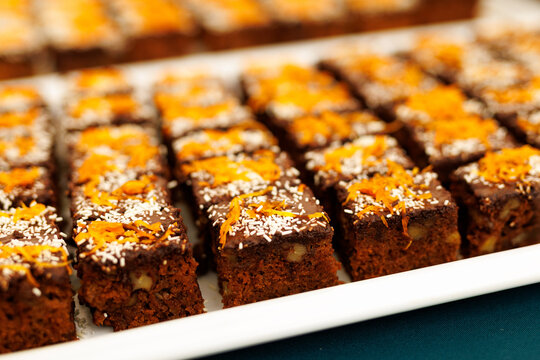 Carrot chocolate cake with coconut and orange zest topping