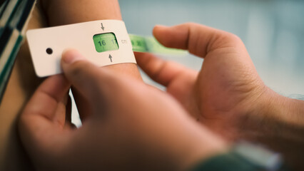 A doctor examines children's malnutrition inside a refugee camp. Malnutrition was measured using a mid-upper arm circumference belt.