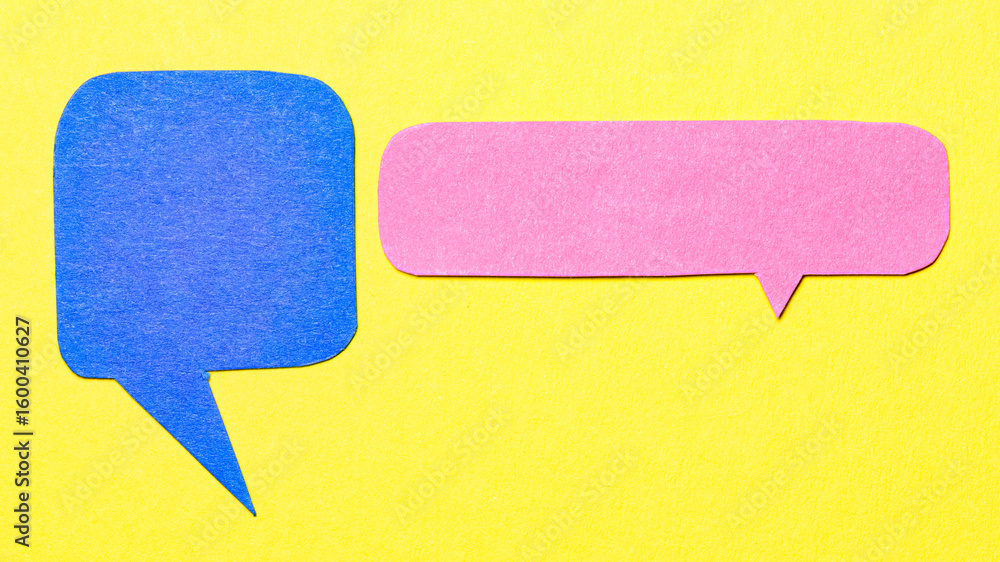 Fototapete blue pink cut out paper speech bubbles with copy space for text on yellow background, flat lay top v