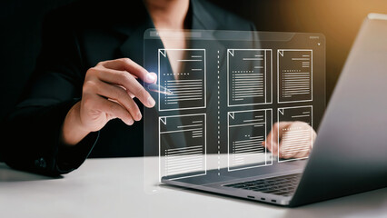Professional using futuristic holographic interface to review documents and data analysis on laptop