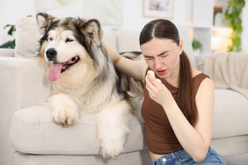 Woman suffering from allergy with her dog at home