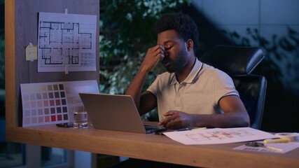 African American architect business man laptop work overtime in night office tired businessman overwork exhausted male guy discomfort evening take off glasses suffer eyesight head ache dry eyes health